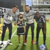 Garoto Bruninho ganha camisa personalizada do Santos e é recebido por jogadores no gramado da Vila
